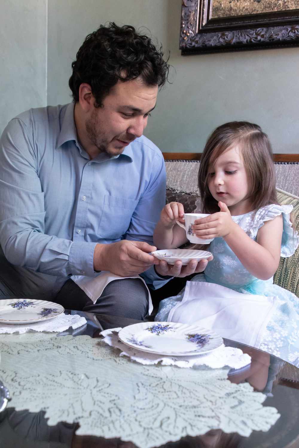 Fine Dining Albuquerque Father helping Daughter lift teacup